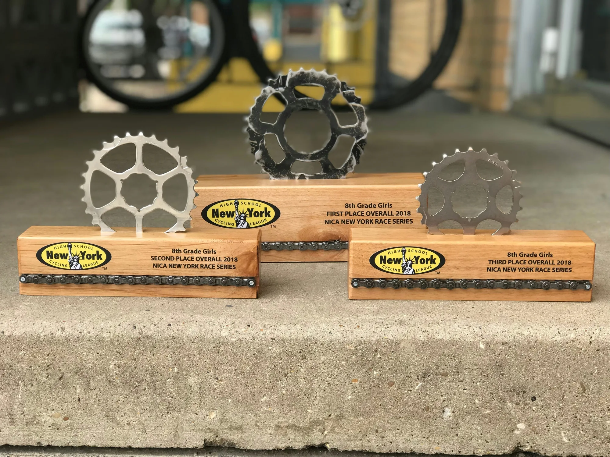 Champion Series wood block trophies with reclaimed gear toppers, small medium and large